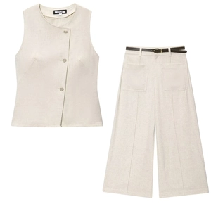 Flat lay of linen vest and wide-leg trousers set with black belt in beige