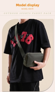 Detail view of large army green nylon belt bag worn crossbody for sports use