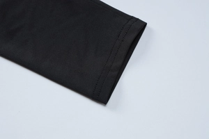 Detail view of the fine double-needle stitching on the black knit fabric sleeve cuff
