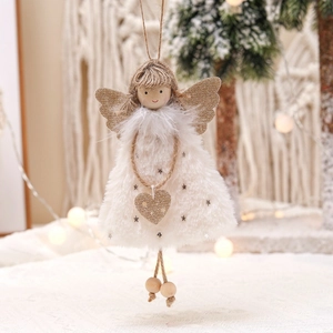Handmade plush Christmas angel ornament with golden wings on festive holiday tree background