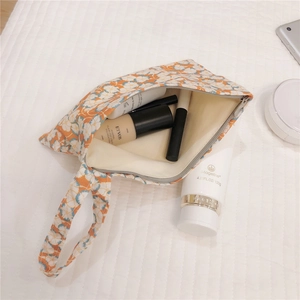 Detail view of floral cotton pouch with zipper and inner lining for cosmetics
