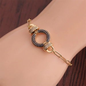 Close-up of gold Hip Hop bracelet with blue and white zircon pavé circular detail