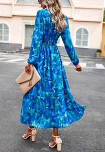 Back view of a flowing blue printed long-sleeve maxi dress with elastic waist