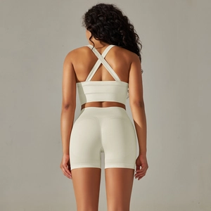 Back view of a seamless ribbed yoga set featuring cross-back sports bra and high waist shorts