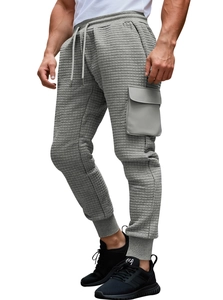 Detail of grey waffle knit joggers featuring a tactical cargo pocket and ribbed cuffs