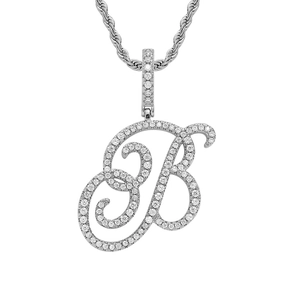 Macro detail of iced-out cursive letter B pendant with silver rope chain for hip-hop style