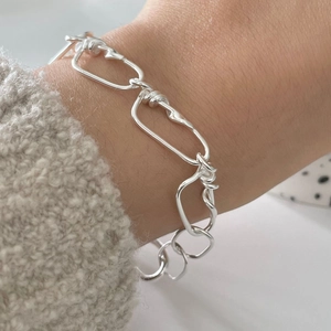 Minimalist 925 sterling silver woven beaded chain bracelet worn on wrist over a sweater