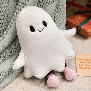 Detailed close-up of cute white plush ghost toy with pink shoes and embroidered face