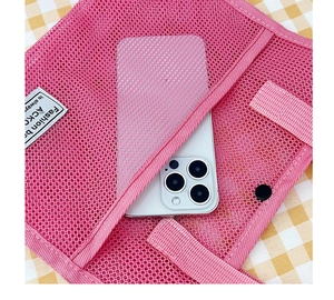 Detail of rose pink mesh bag showing side pocket with smartphone for size reference