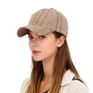 Detailed side view of a brown plaid baseball cap on a model with a classic stiff crown