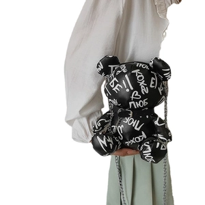 Graffiti bear crossbody bag with silver chain strap and stylish black leather finish