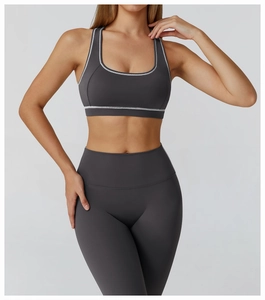 Detail view of racerback yoga bra and high waist leggings with white contrast binding