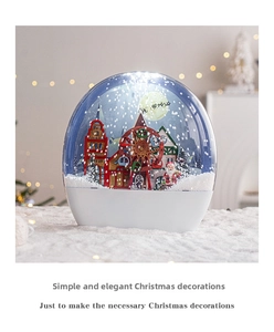 Macro view of Christmas snow globe featuring a colorful ferris wheel and miniature house