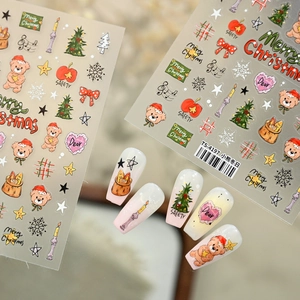 Christmas bear nail art stickers featuring trees, snowflakes and bows on manicured tips