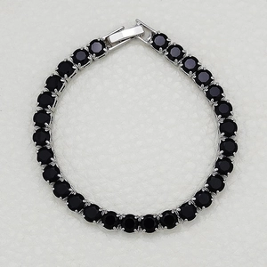 Detailed top view of silver tennis bracelet with black cubic zirconia and secure clasp