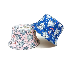 Detail of kids bucket hats featuring cute koala prints in pink and blue cotton fabric