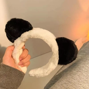 Close-up of soft plush headband with cute bear ears in classic black and white style