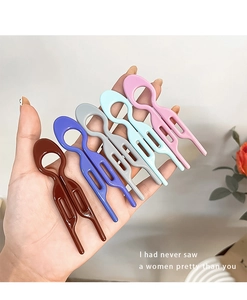 Close-up of five colorful matte plastic U-shaped hairpins in assorted candy colors