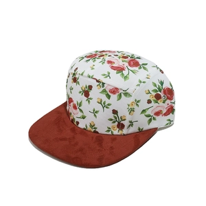Detail of floral print camper cap with red suede brim and metal ventilation eyelets