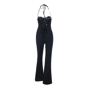 Detail of sexy black halter neck jumpsuit featuring a criss-cross lace-up open back design
