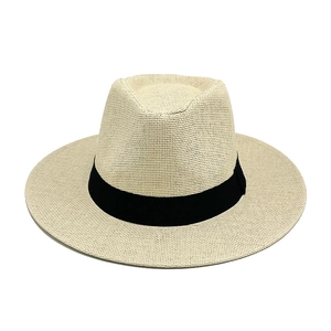 Close-up of woven texture on Panama straw hat with a stylish black ribbon band