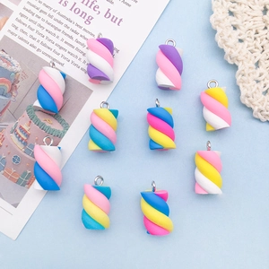 Macro detail of twisted resin marshmallow charms with colorful spiral textures and metal hooks