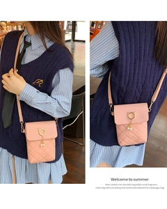 Pink quilted phone bag with pearl charm shown from front and side angles on a model