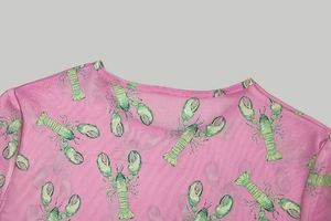 Detail of pink mesh top featuring green lobster print and sheer fabric texture