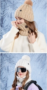 Detailed knit texture of winter hat and scarf set with wooden button and faux fur pompom