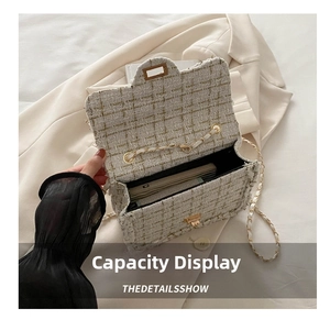 Detail view showing the spacious interior compartment of the tweed chain crossbody bag