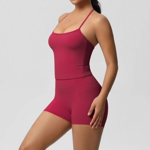 Detail view of burgundy yoga set featuring strappy sports top and high waist fitness shorts