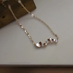 14k gold plated sterling silver necklace with heart-shaped pendants and cubic zirconia