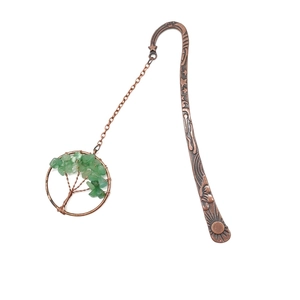 Detail of vintage bronze bookmark with Tree of Life pendant and green crystal stones