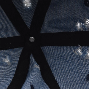 Macro detail of the interior reinforced stitching and metal rivet of the denim baseball cap