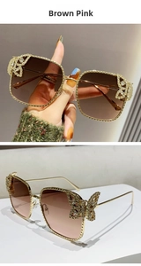 Detail of butterfly rhinestone embellishment on brown pink gradient sunglasses