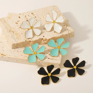 Floral stud earrings set in white, turquoise and black with golden borders on stone