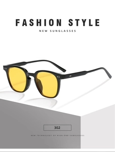 Detail of retro square sunglasses featuring black frames and yellow lenses with rice studs