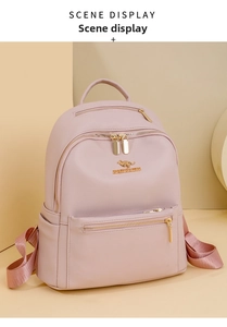 Detailed view of pink lychee grain faux leather backpack with golden kangaroo logo
