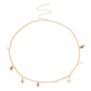 Detailed view of bohemian gold chain belt featuring delicate shells and pearl charms