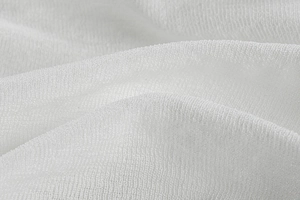 Vue macro détaillée du tissu en maille blanche respirante avec texture froncée élégante