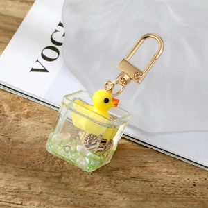 Macro view of square resin keychain featuring a yellow duck and sea shells inside