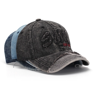 Detail of vintage washed denim baseball cap with 3D SMILE embroidery and distressed holes
