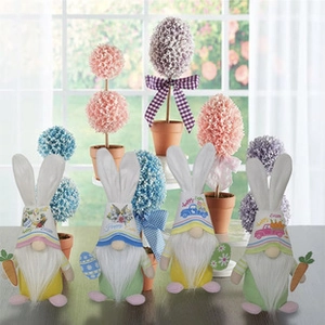 Detailed view of plush Easter gnomes with Happy Easter embroidery and colorful faux plants