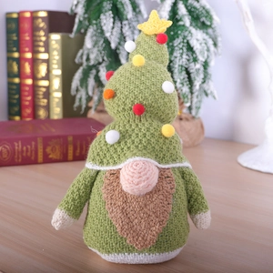 Knitted Christmas gnome ornament with green hat and brown beard on vintage books