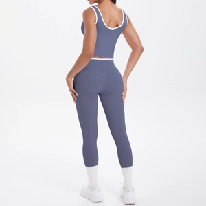 Detail view of smog blue yoga set with racerback top and high-waist leggings and white piping