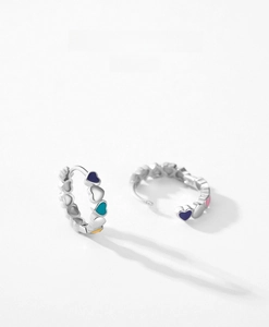 Detailed macro view of S925 sterling silver hoop earrings with colorful enamel hearts