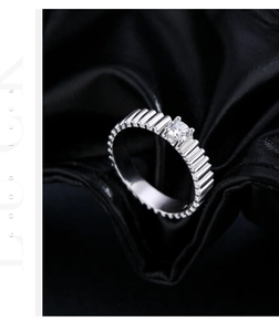 Detailed close-up of S925 silver ring with sparkling round moissanite and ribbed band