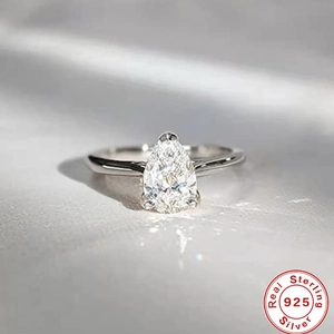 Macro detail of pear-shaped clear gemstone ring in 925 sterling silver with auth stamp