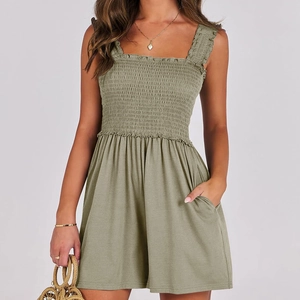 Close-up of olive green romper with smocked elastic bodice and soft cotton texture