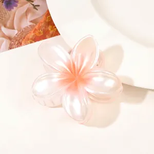 Close-up of a pearlescent pink gradient flower hair claw clip with smooth edges